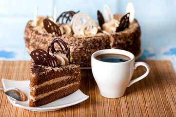 coffee ,a slice of cake on the plate on the background of cake