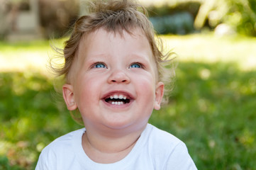 child with curly hair smiles