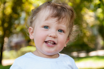 child with curly hair smiles