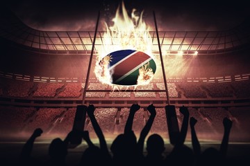 Composite image of silhouettes of football supporters