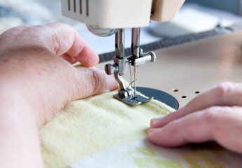 elderly woman sewing on the sewing machine