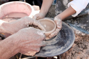 hand of the potter and the child in the creation of new products