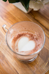 Finish a cup of cappucino with heart shape on bubble milk