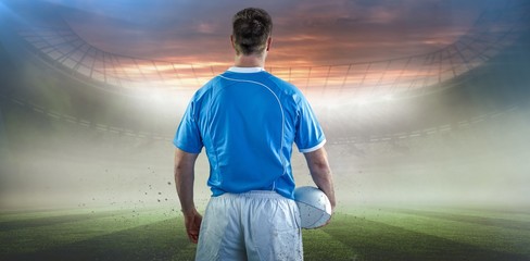 Composite image of rugby player holding a rugby ball © vectorfusionart