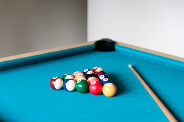 cue and balls are on the table for billiard