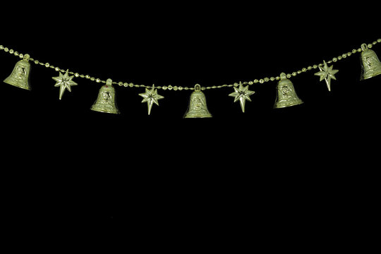 Christmas Golden bell chain on black background 