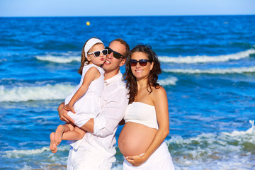 Family on the beach pregnant mother