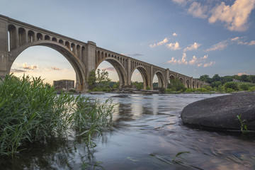 This concrete arch railroad bridge spanning the James River was built by the Atlantic Coast Line, Fredericksburg and Potomac Railroad in 1919 to route transportation of freight around Richmond, VA. - obrazy, fototapety, plakaty
