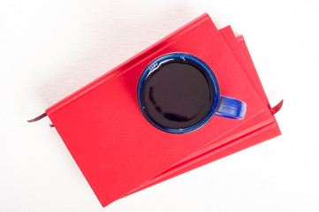 Cup of tea or coffee on stack of books. Textbooks and drink. Stu