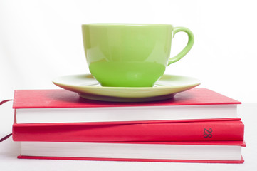 Cup of tea on books stack. Concept of reading, studying or resti