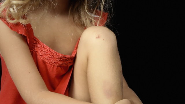 Little girl band aid knee sitting applying