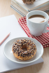 Donut chocolate with a cup of coffee.