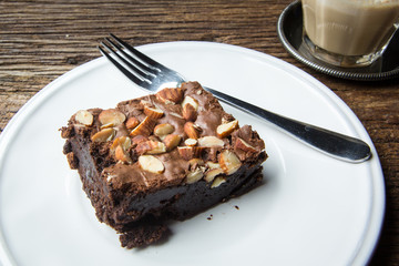 Cake chocolate brownies on wooden table in the coffee shop
