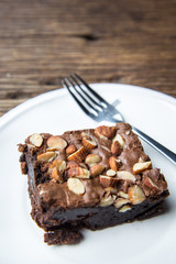 Cake chocolate brownies on wooden table in the coffee shop
