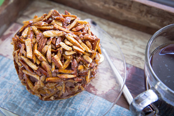 chocolate cake with almond nut on top and hot americano coffee