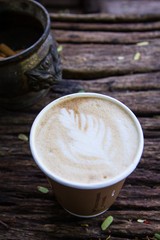 A Cup of hot latte art coffee on wooden table