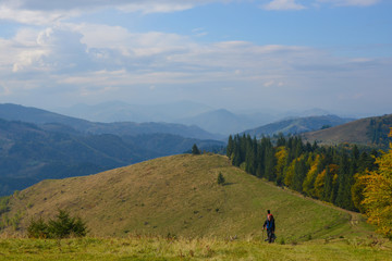 Fototapeta na wymiar Hikers are walking to the autumn mountains .
