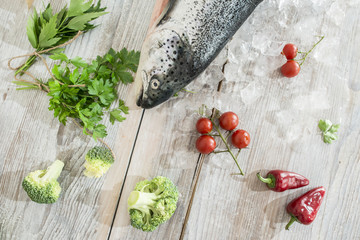 Raw salmon fish in ice and vegetables