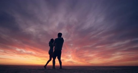 Happy couple dancing on beach enjoying honeymoon in nature at sunset silhouetted wide shot RED DRAGON - Powered by Adobe