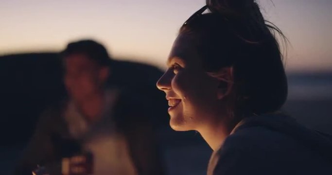 Beach Party at sunset with bonfire and roasting marshmellows with friends
