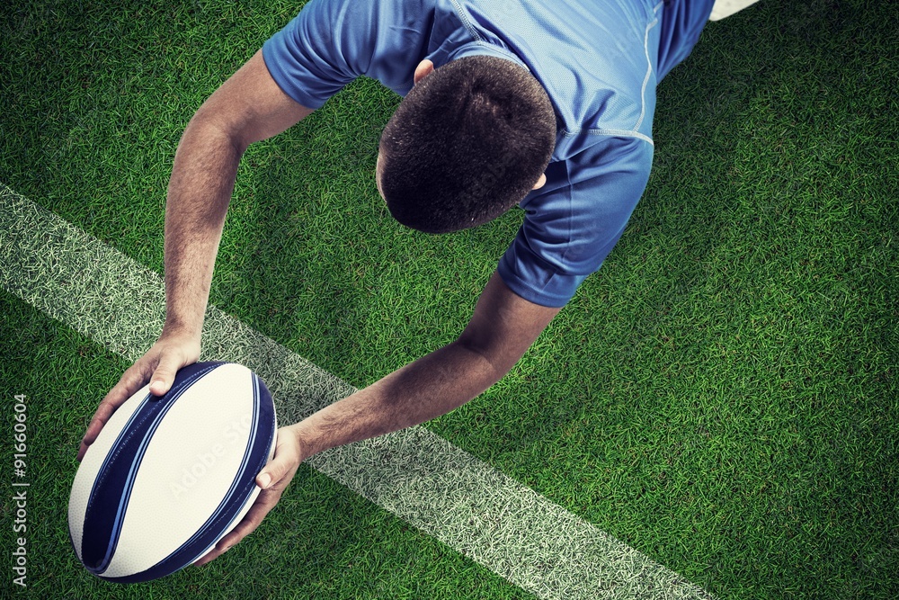 Poster composite image of rugby player lying in front with ball