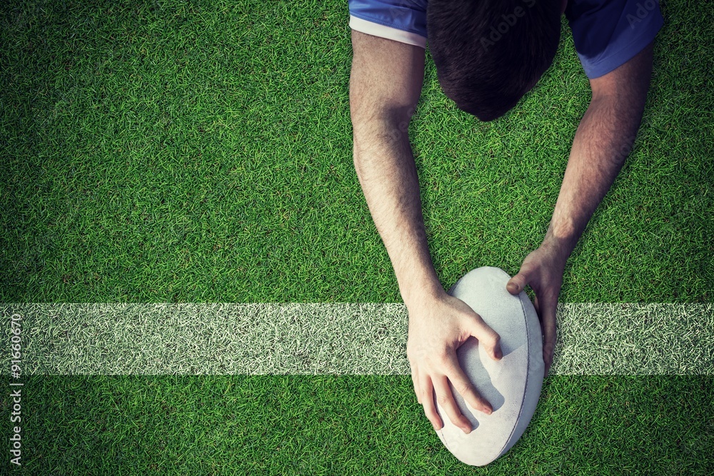 Poster composite image of a rugby player scoring a try