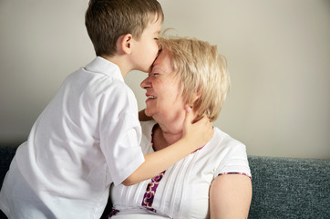 Fototapeta premium grandson kissing his grandmother
