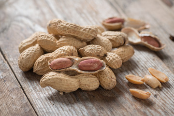 Close up, Peeled Peanut on wood background.