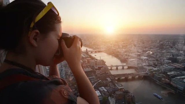 Tourist taking photograph sunset london skyline cityscape view from The Shard