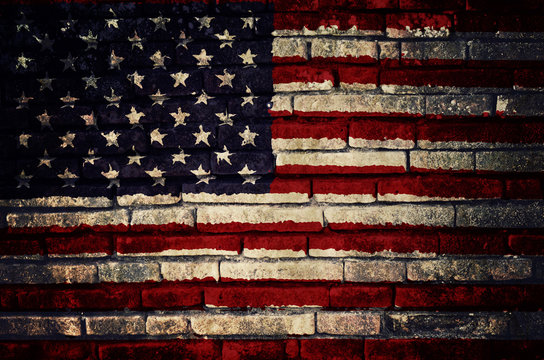 Flag of United States of America painted on dirty brick wall