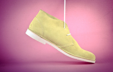 Green male shoes on pink background