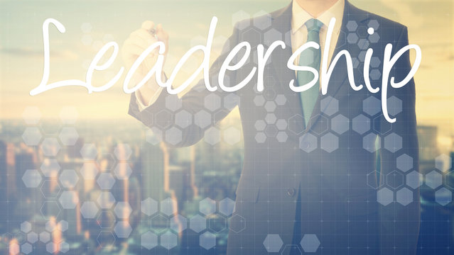 businessman write on transparent board Leadership with sunset ov
