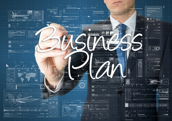 the businessman is writing Business Plan on the transparent boar