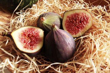 fresh purple figs on a wooden plate