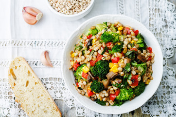 barley porridge with corn, broccoli, garlic, mushrooms and peppe