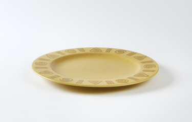 Handmade pottery plate with decorated rim