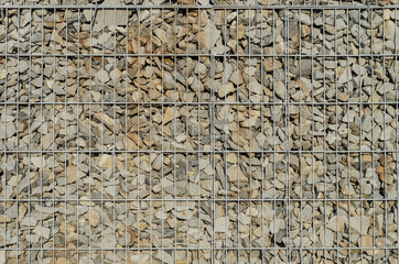 Gabion retaining wall - grey stones in gabion baskets kept by retaining wall wire mesh