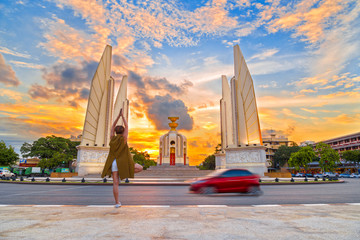 Girl doing yoga balances during sunset sunrise at Democracy monu