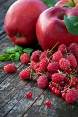 Concept of red berries and fruits on wooden board