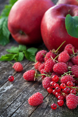 Concept of red berries and fruits on wooden board