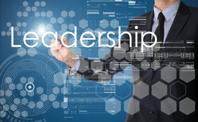 businessman writing Leadership and drawing graphs and diagrams o