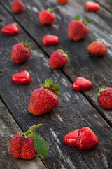 Strawberries and candy on wooden table
