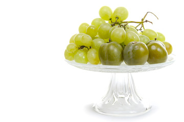 Fresh ripe white grapes clusters in a cup on white background