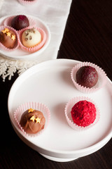 chocolate candies on white tray, close up vertical
