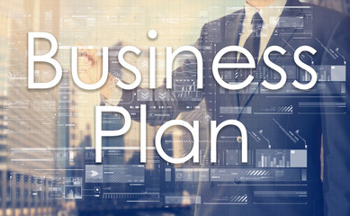 businessman writes on board text: Business Plan - with sunset ov