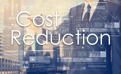 businessman writes on board text: Cost Reduction - with sunset o