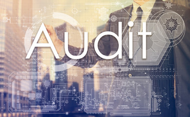 businessman writes on board text: Audit - with sunset over the c