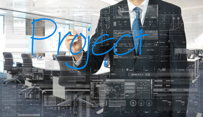 businessman writing on transparent board Project with office in