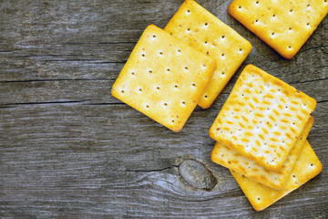 Biscuits salty crackers on an old wooden background