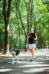 Naklejka na ściany i meble work out with dog. Young caucasian male running with siberian hu